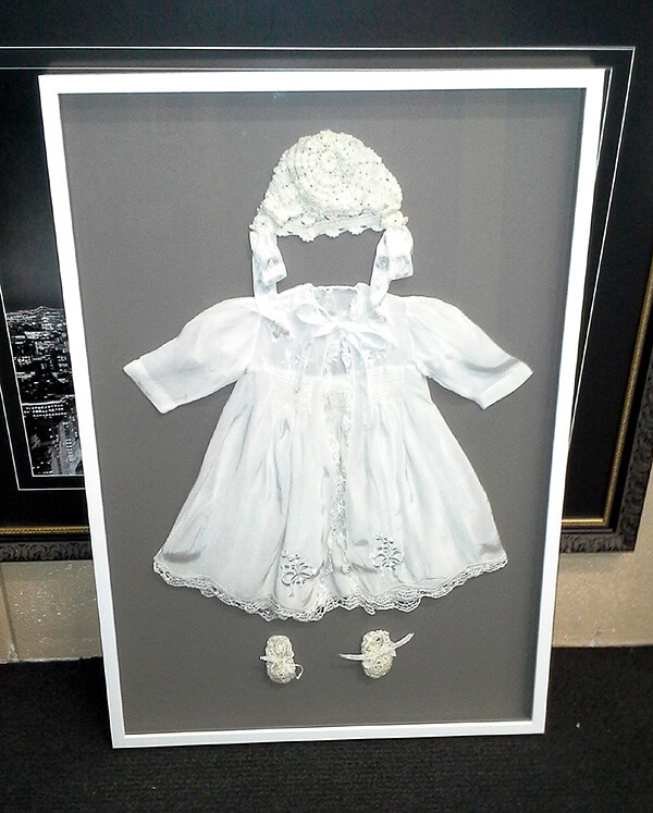 hand-stitched antique lace christening gown in shadow box frame