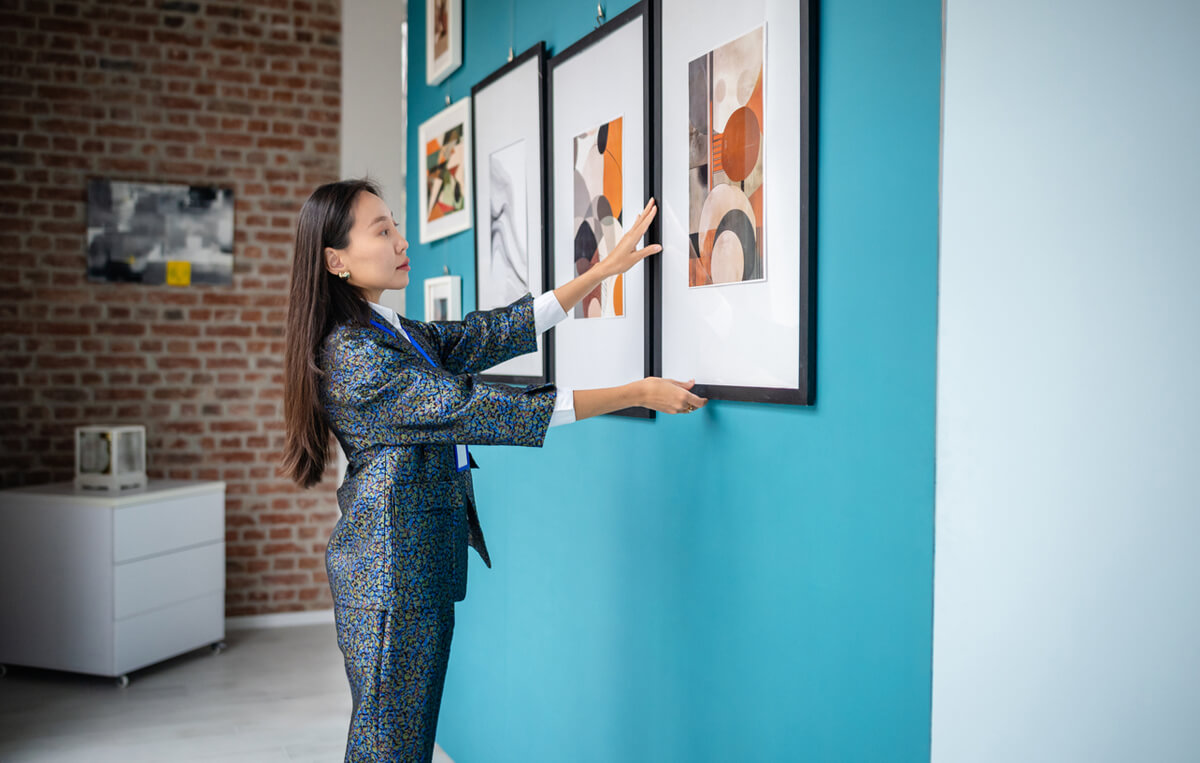 Consistent professional gallery framing artists Gallery wall of consistently framed artworks at a solo exhibition