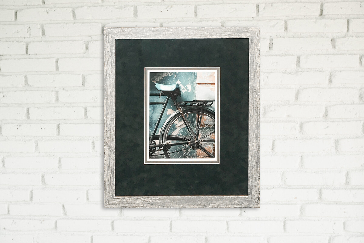 Dark mat board on brick wall Framed print showing dark mat board